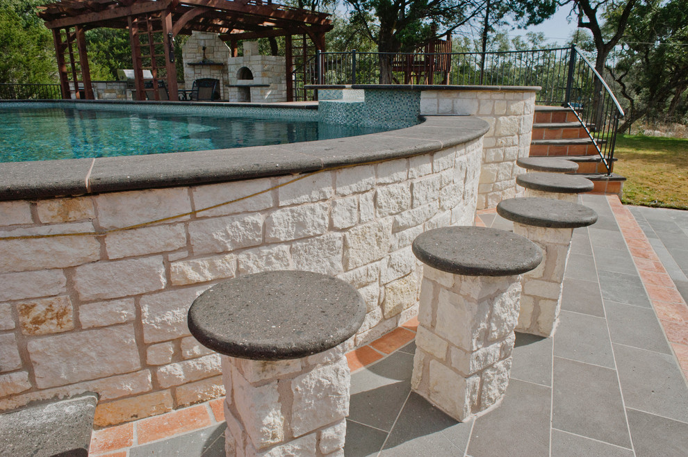 Design ideas for an expansive country backyard custom-shaped aboveground pool in Austin with a hot tub and tile.