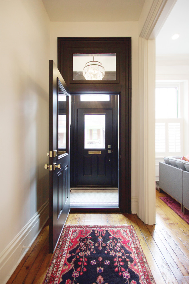 Inspiration for a small traditional vestibule in Other with ceramic floors, a single front door and a black front door.