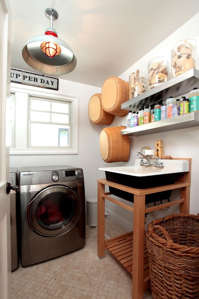Eclectic dedicated laundry room in Los Angeles with a drop-in sink and a side-by-side washer and dryer.