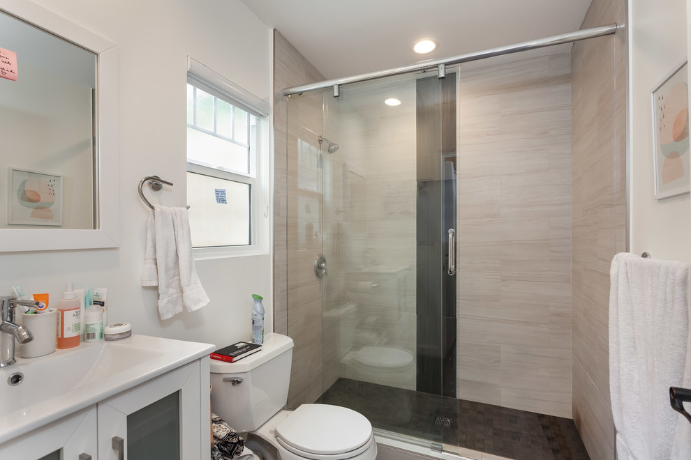 Design ideas for a mid-sized contemporary master bathroom in Los Angeles with flat-panel cabinets, white cabinets, white benchtops, an alcove shower, a two-piece toilet, white tile, white walls, medium hardwood floors, a drop-in sink, zinc benchtops, brown floor and a sliding shower screen.