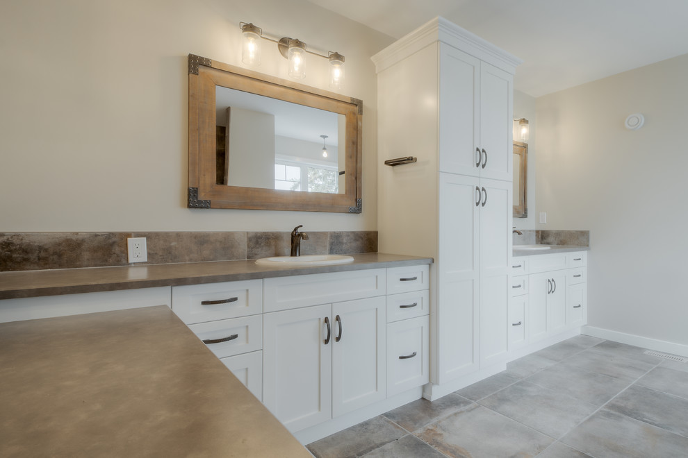 Inspiration for a small arts and crafts master bathroom in Calgary with shaker cabinets, white cabinets, a drop-in tub, an alcove shower, a two-piece toilet, white tile, subway tile, beige walls, medium hardwood floors, a drop-in sink, laminate benchtops, brown floor and white benchtops.