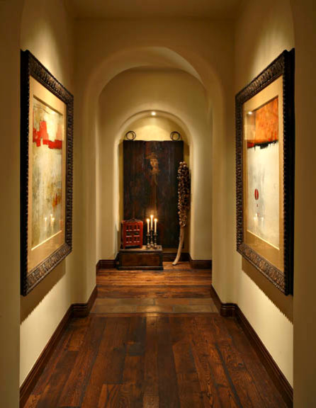 Large mediterranean hallway in Phoenix with dark hardwood floors, beige walls and brown floor.