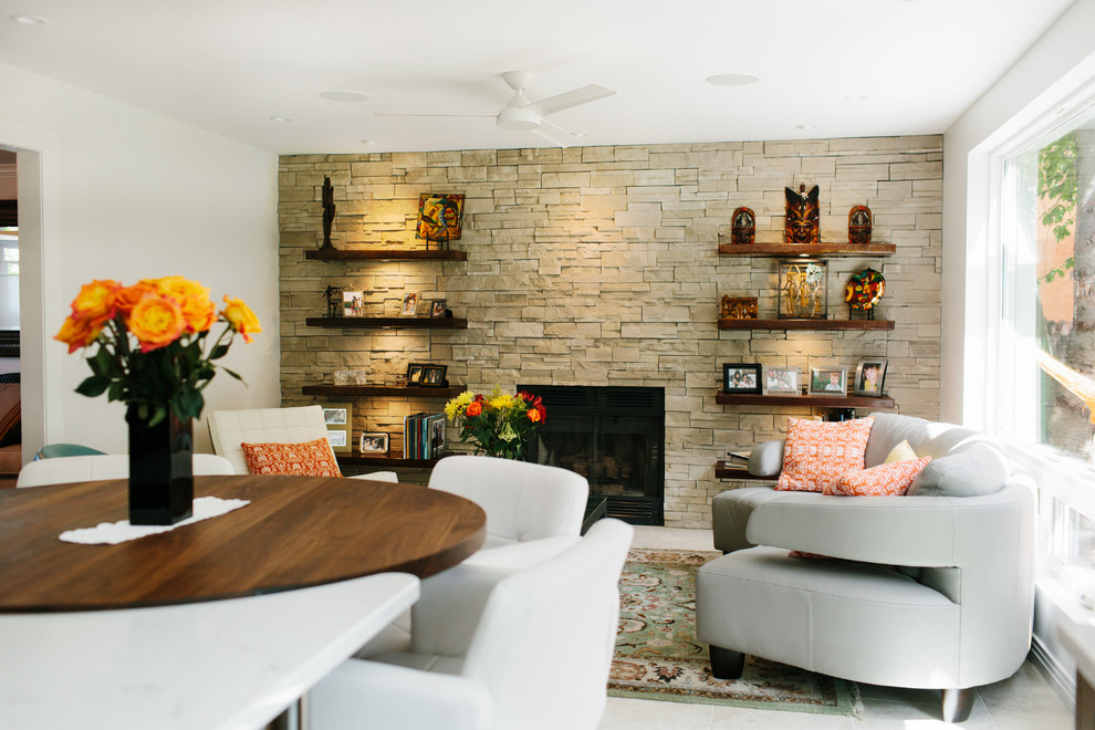 Inspiration for a mid-sized transitional open concept living room in Seattle with white walls, ceramic floors, a standard fireplace, a stone fireplace surround and beige floor.