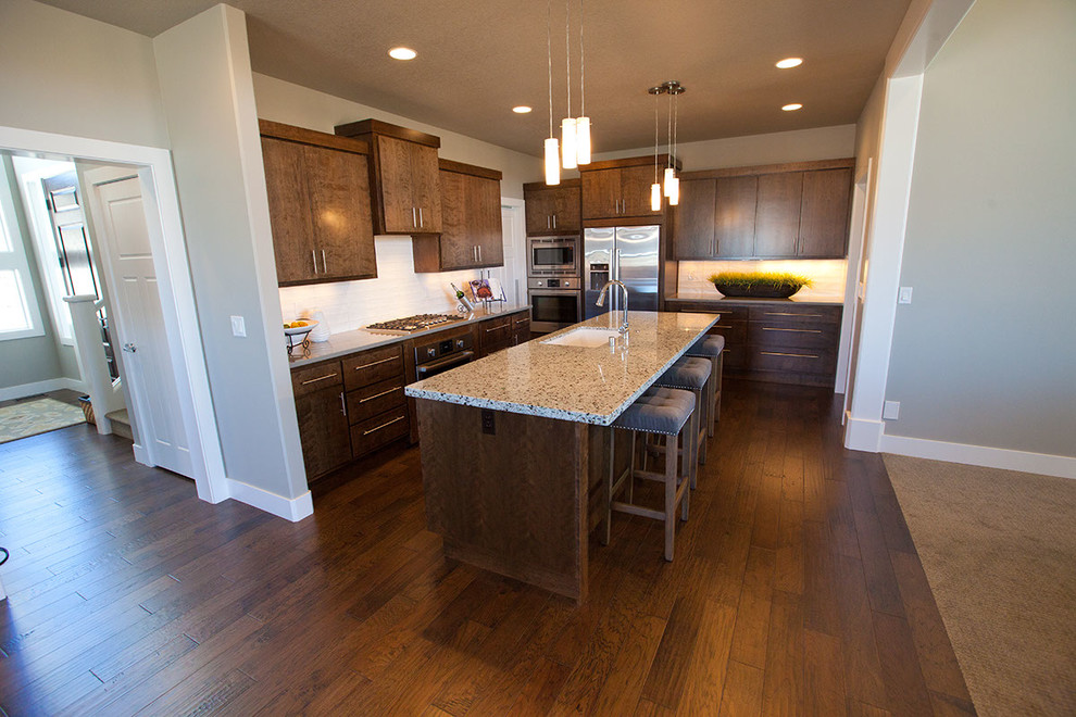Transitional eat-in kitchen photo in Seattle with flat-panel cabinets and an island