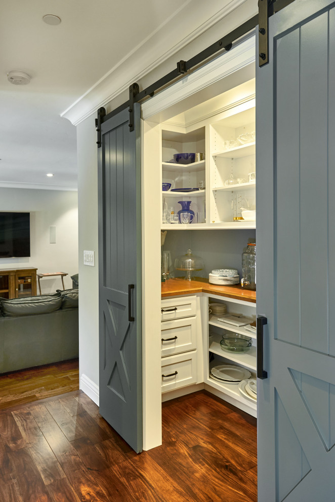 Example of a small transitional u-shaped dark wood floor and brown floor kitchen pantry design in San Francisco with recessed-panel cabinets, white cabinets, wood countertops, gray backsplash and brown countertops