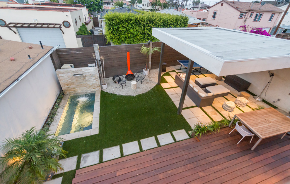 Design ideas for a mid-sized contemporary backyard patio in Los Angeles with a fire feature, concrete pavers and a gazebo/cabana.