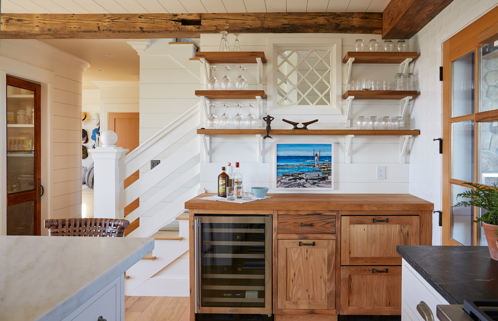 Design ideas for a beach style single-wall home bar in Portland Maine with no sink, shaker cabinets, medium wood cabinets, wood benchtops and white splashback.