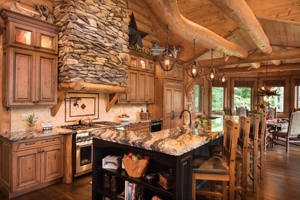 Design ideas for an expansive country eat-in kitchen in Portland Maine with medium wood cabinets, granite benchtops, beige splashback, stone tile splashback, medium hardwood floors, with island, brown floor, raised-panel cabinets and panelled appliances.