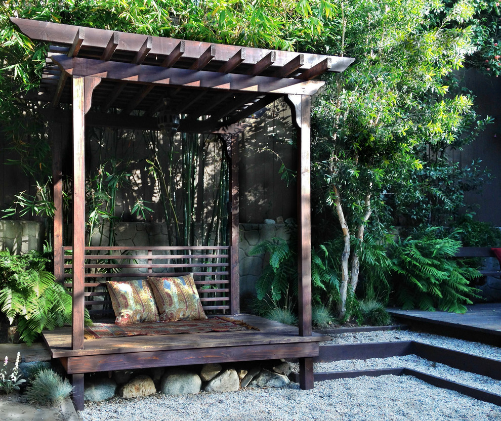 Design ideas for a small asian backyard partial sun xeriscape in Los Angeles with decking.