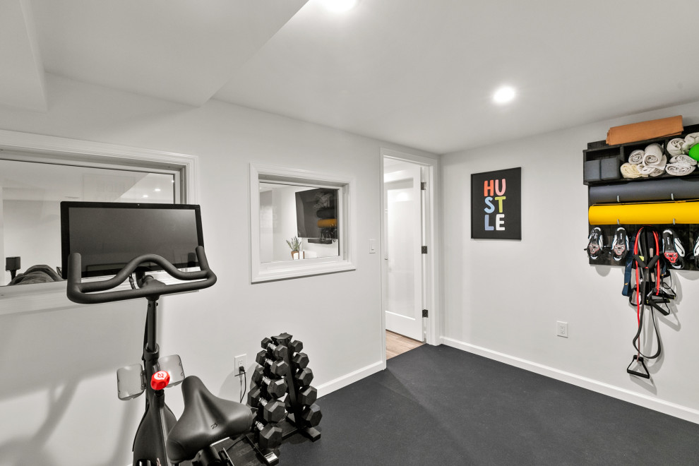 Design ideas for a small classic multi-use home gym in Philadelphia with white walls and black floors.
