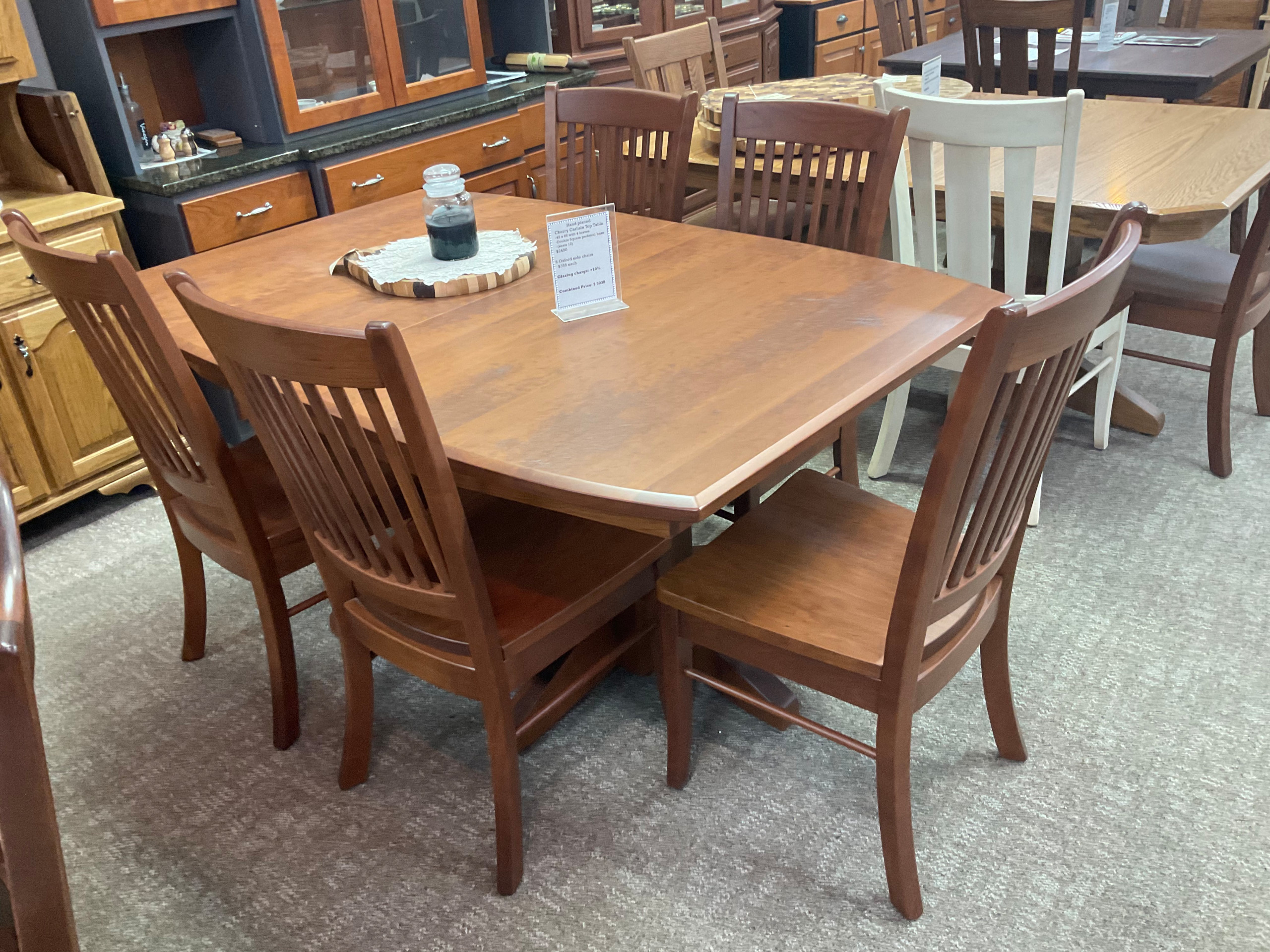 Hand planed cherry boat shaped table with 4 leaves. Carlisle chairs