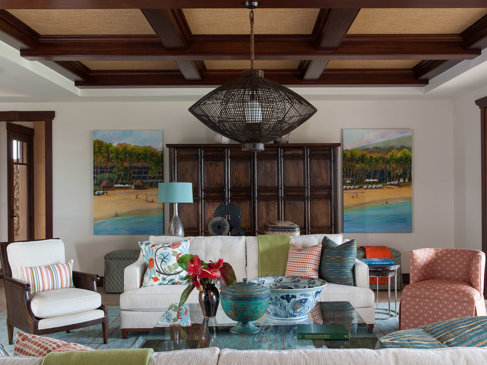 Inspiration for a large tropical open concept living room in Hawaii with white walls and no fireplace.
