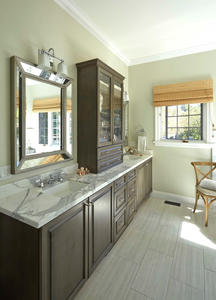 Large traditional master bathroom in San Francisco with an undermount sink, raised-panel cabinets, dark wood cabinets, marble benchtops, a freestanding tub, a corner shower, a two-piece toilet, white tile, ceramic tile, green walls and ceramic floors.