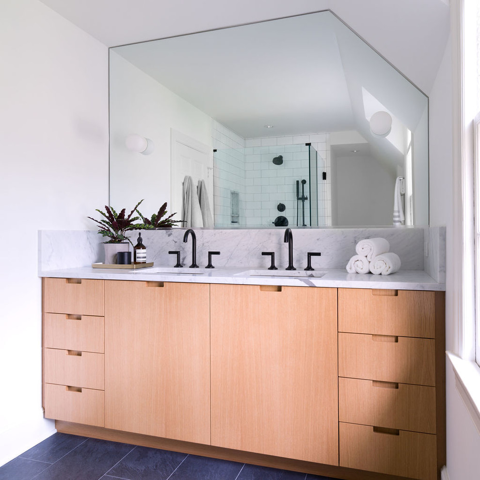 Inspiration for a modern master bathroom in Other with flat-panel cabinets, medium wood cabinets, a corner shower, a one-piece toilet, red tile, subway tile, white walls, slate floors, an undermount sink, marble benchtops, grey floor, a hinged shower door and grey benchtops.