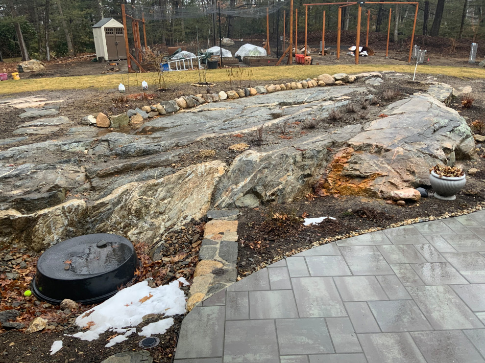 How to lay patio over existing rock ledge?