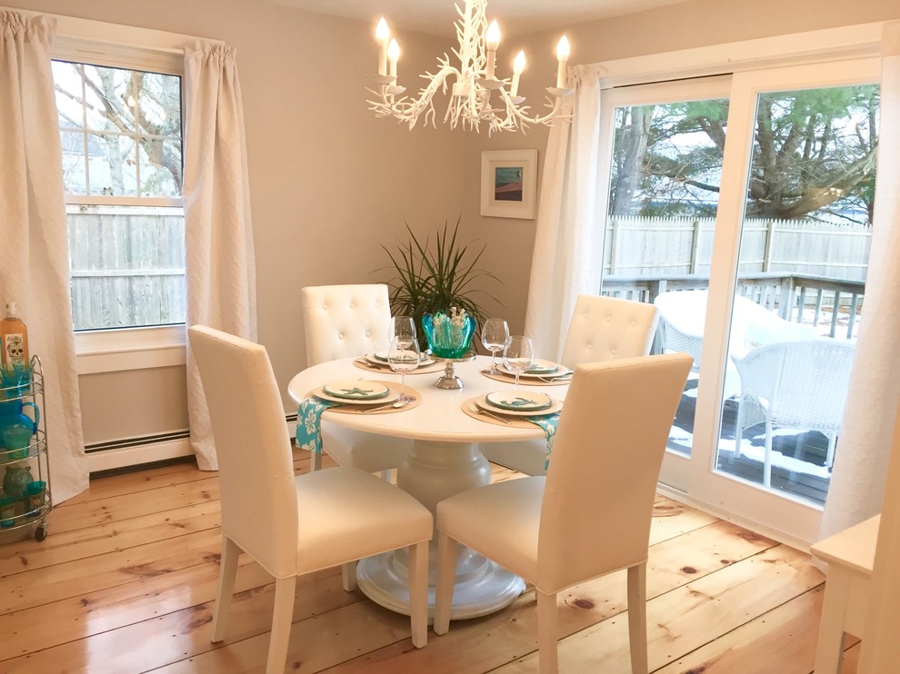 Photo of a small beach style dining room in Boston with grey walls, light hardwood floors and beige floor.