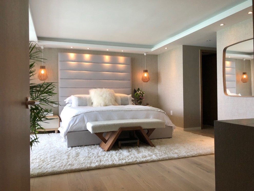 Mid-sized minimalist master light wood floor and white floor bedroom photo in Miami with beige walls
