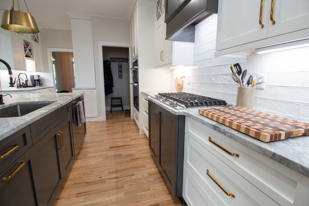 Large l-shaped eat-in kitchen photo with shaker cabinets, white cabinets, granite countertops, an island and white countertops