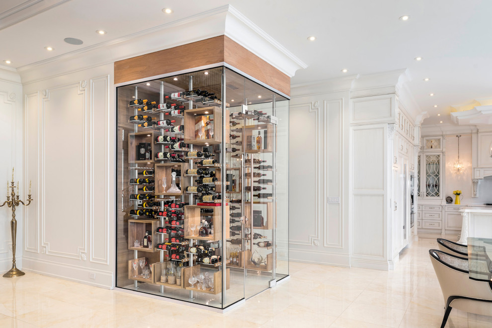 Mid-sized modern wine cellar in Toronto with display racks and beige floor.