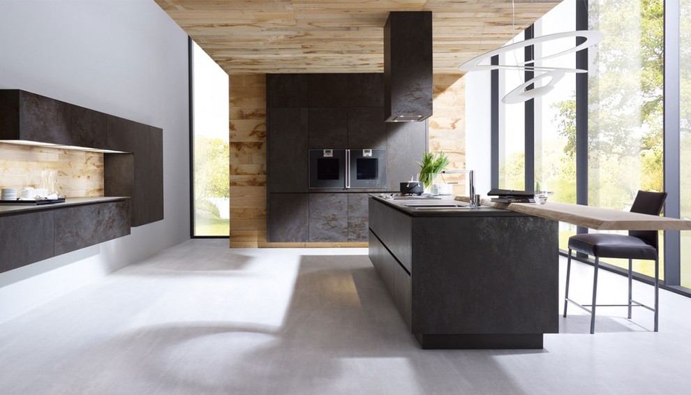 This is an example of a mid-sized modern single-wall eat-in kitchen in New York with flat-panel cabinets, stainless steel cabinets, brown splashback, timber splashback, panelled appliances, cement tiles, with island and grey floor.