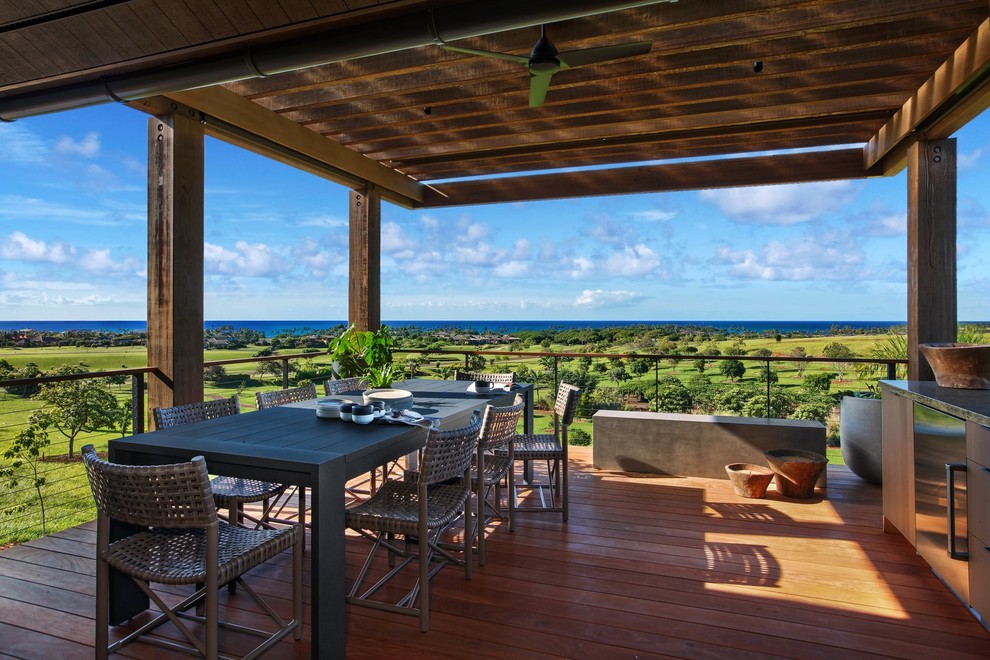 Inspiration for a large tropical backyard deck in Hawaii with a pergola.