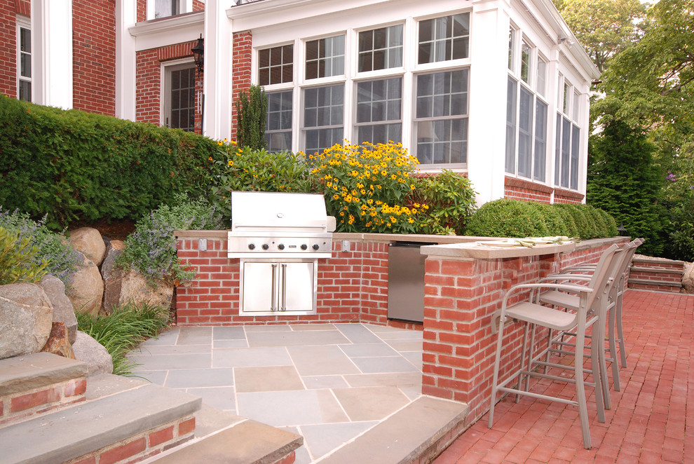Transitional patio in New York with natural stone pavers.