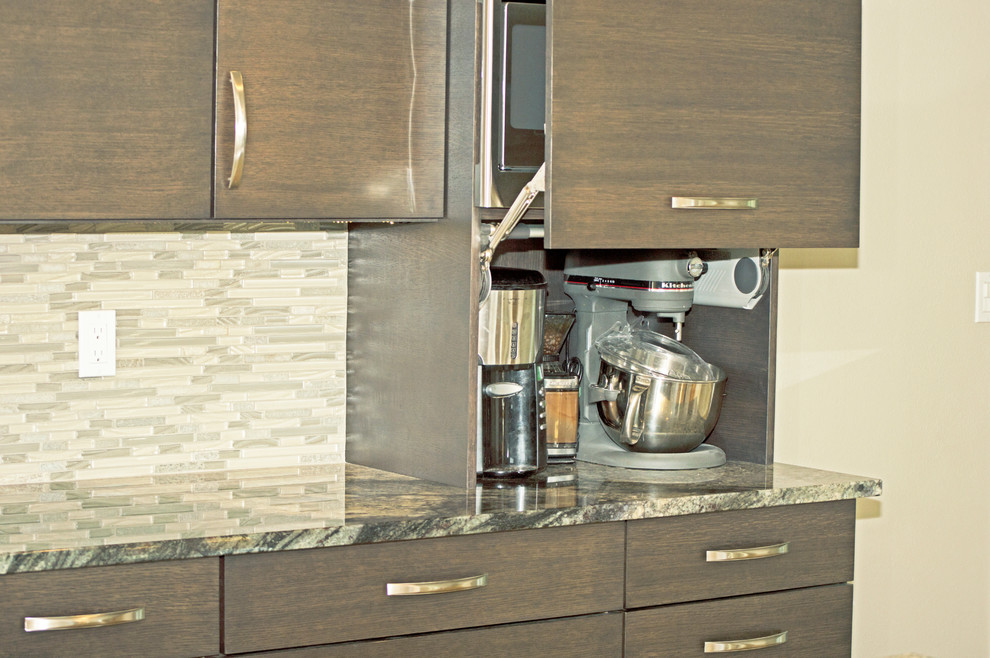 Eat-in kitchen - large transitional l-shaped light wood floor eat-in kitchen idea in Seattle with an undermount sink, flat-panel cabinets, dark wood cabinets, granite countertops, green backsplash, glass tile backsplash, stainless steel appliances and an island