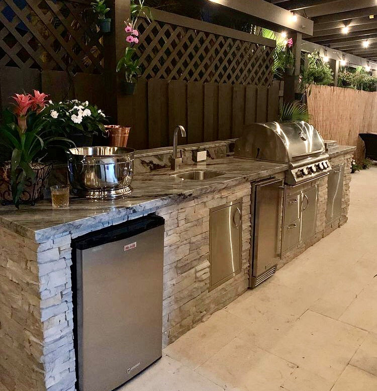 Example of a mid-sized classic backyard tile patio kitchen design in Miami with a pergola