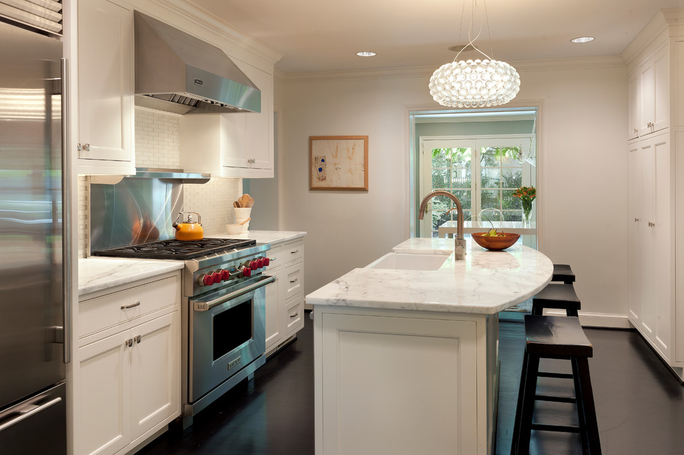 Inspiration for a traditional single-wall eat-in kitchen in DC Metro with stainless steel appliances, a farmhouse sink, recessed-panel cabinets, white cabinets, marble benchtops, white splashback, ceramic splashback, dark hardwood floors, with island, black floor and multi-coloured benchtop.