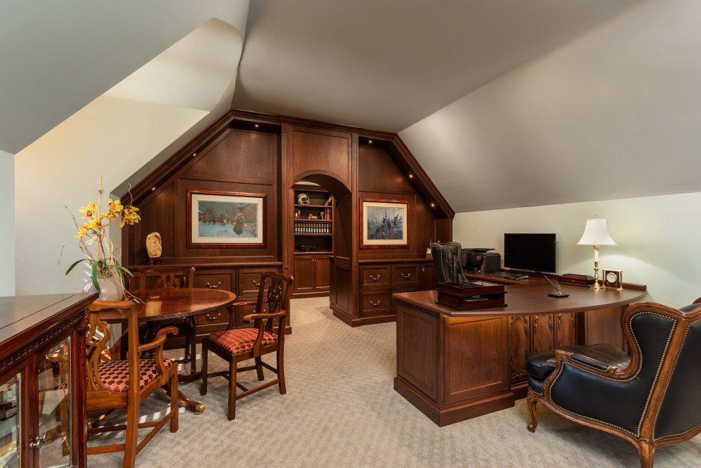 Photo of a large traditional home office with carpet and a built-in desk.
