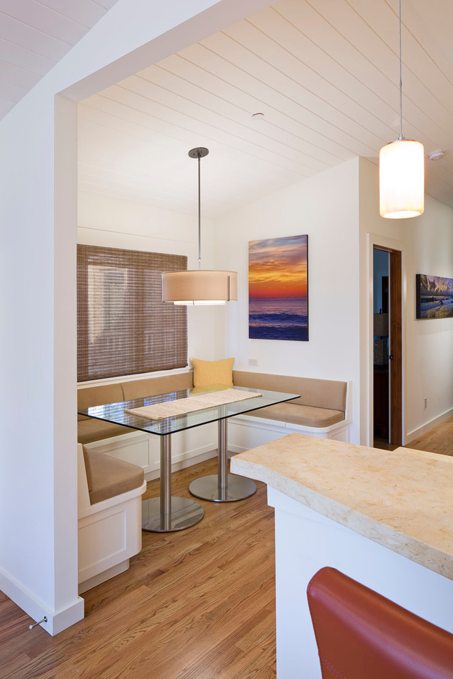 Inspiration for a beach style dining room in San Francisco with white walls and light hardwood floors.