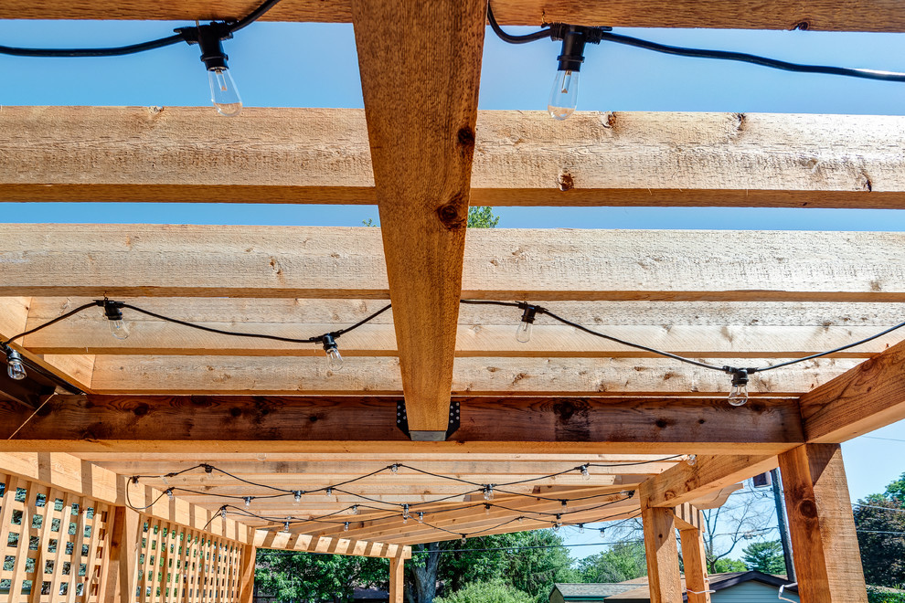 Deck - large transitional backyard deck idea in Chicago with a pergola