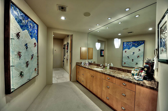 Large contemporary master bathroom in Phoenix with flat-panel cabinets, medium wood cabinets, an alcove tub, a curbless shower, a two-piece toilet, white tile, ceramic tile, beige walls, porcelain floors, a drop-in sink, granite benchtops, beige floor, a hinged shower door and multi-coloured benchtops.