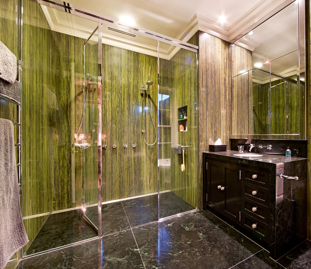 Inspiration for a mid-sized contemporary master bathroom in Melbourne with a drop-in sink, recessed-panel cabinets, black cabinets, marble benchtops, a freestanding tub, a double shower, a one-piece toilet, green tile, stone slab, green walls and marble floors.