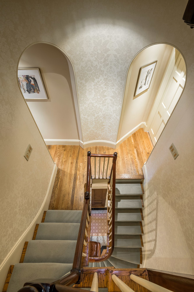 Inspiration for a large traditional wood u-shaped staircase in Boston with wood risers.