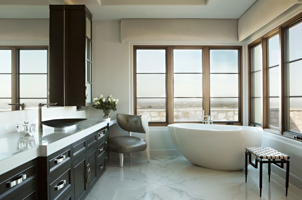 Large contemporary master bathroom in San Diego with a vessel sink, recessed-panel cabinets, black cabinets, engineered quartz benchtops, a freestanding tub, a double shower, a wall-mount toilet, black and white tile, stone slab, white walls and marble floors.