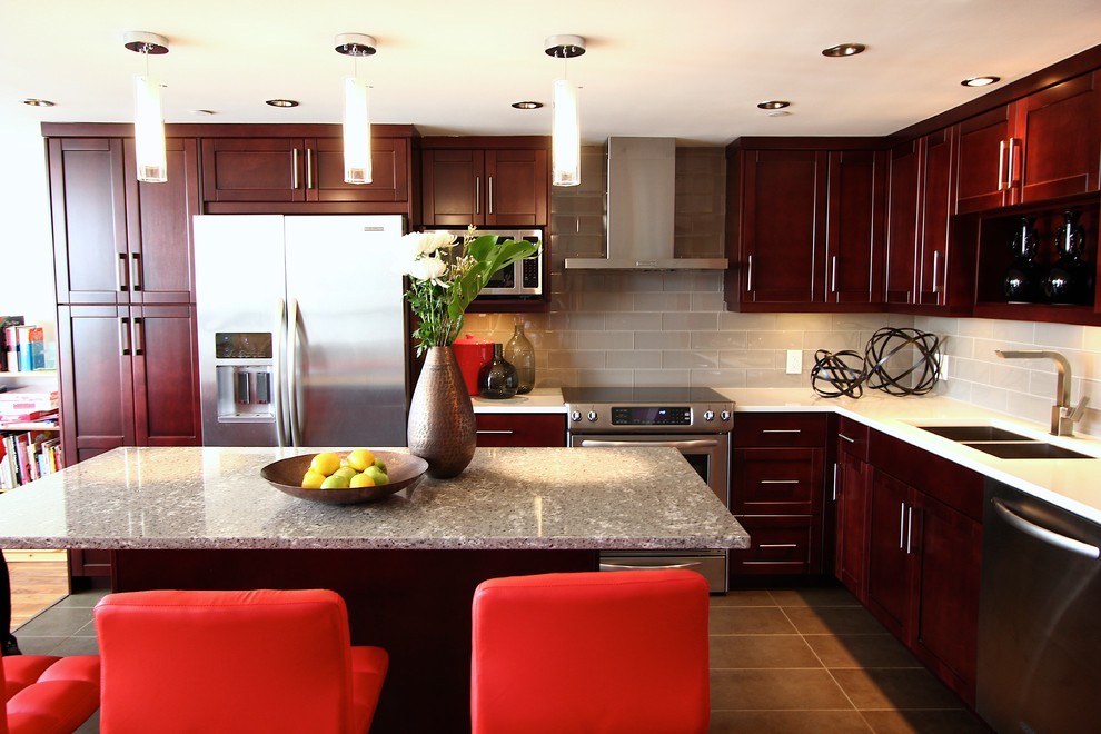 Inspiration for a mid-sized mediterranean l-shaped porcelain tile eat-in kitchen remodel with a double-bowl sink, shaker cabinets, dark wood cabinets, quartzite countertops, white backsplash, glass tile backsplash, stainless steel appliances and an island