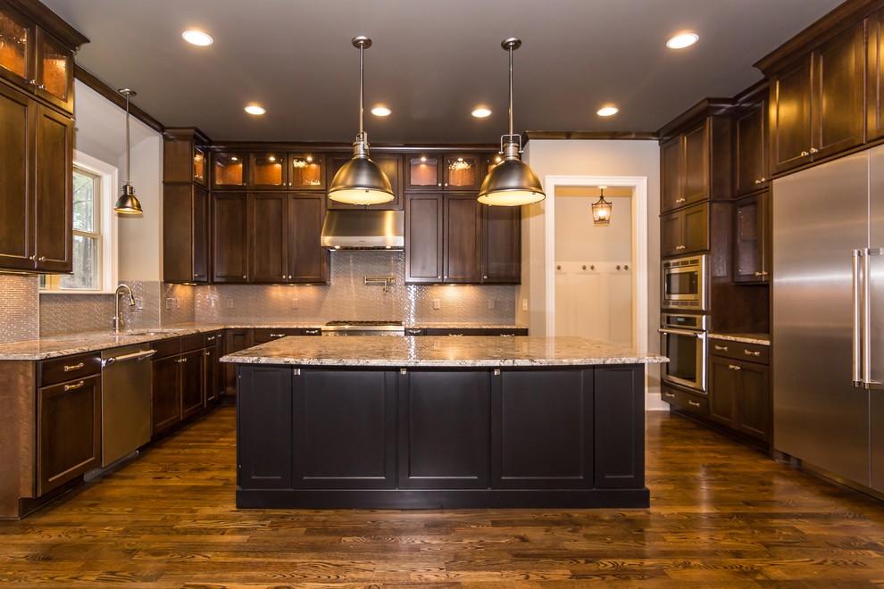 Inspiration for an expansive traditional u-shaped eat-in kitchen in Raleigh with an undermount sink, flat-panel cabinets, medium wood cabinets, granite benchtops, orange splashback, porcelain splashback, stainless steel appliances, medium hardwood floors and with island.