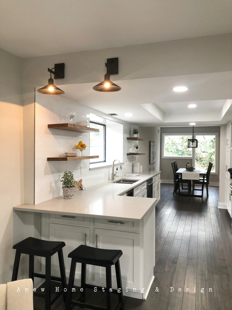 This is an example of a modern l-shaped kitchen/diner in Atlanta with open cabinets, quartz worktops, white splashback, metro tiled splashback and grey worktops.