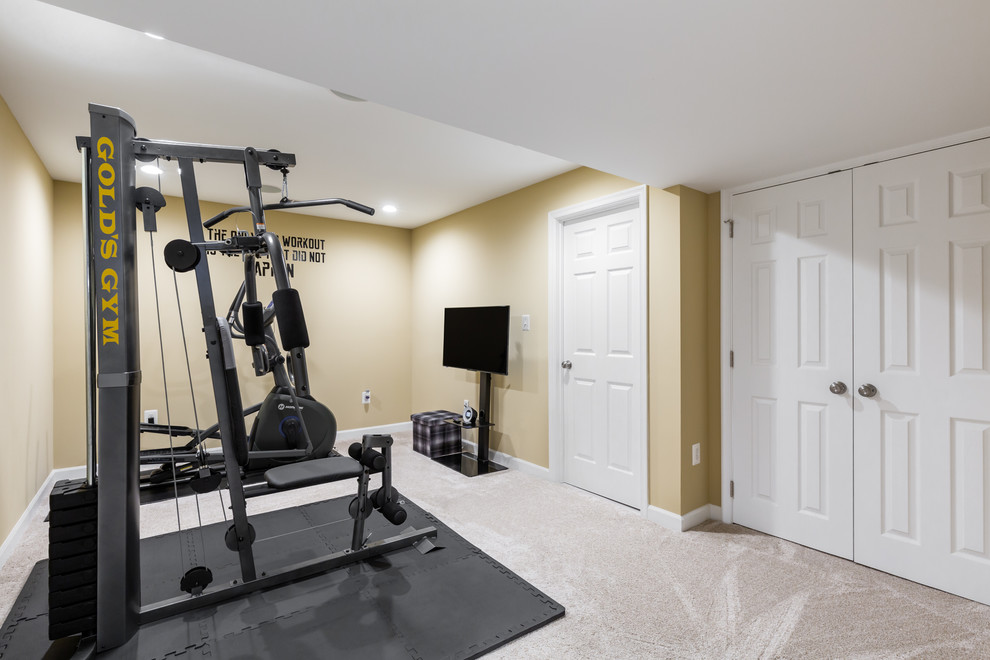 This is an example of a mid-sized contemporary multipurpose gym in DC Metro with yellow walls, carpet and beige floor.