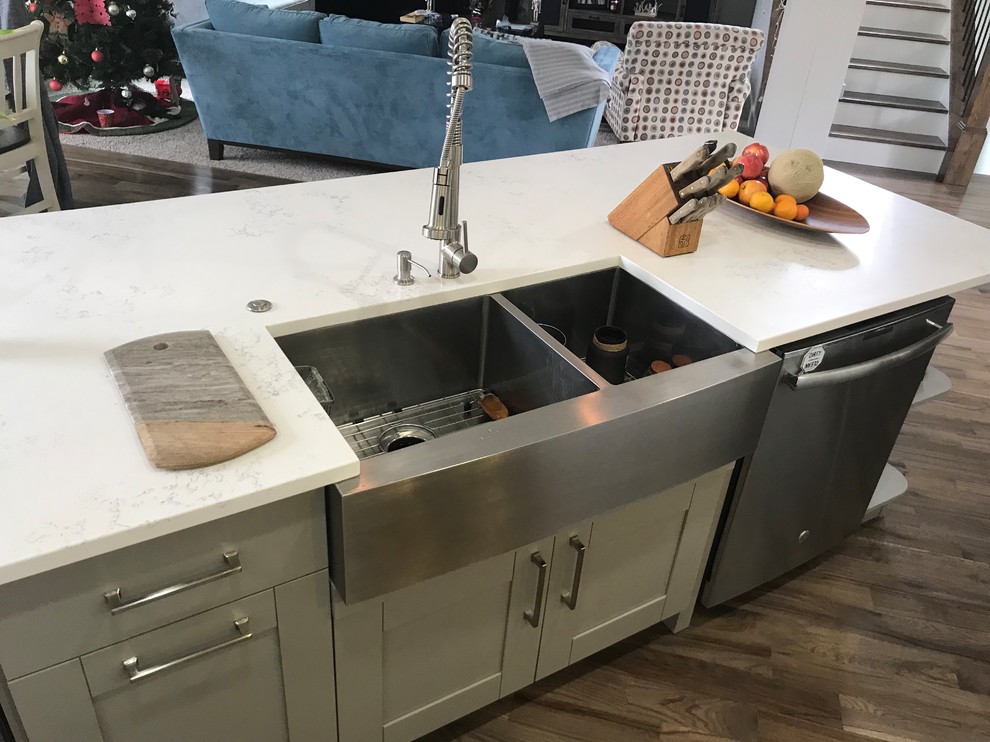 Eat-in kitchen - large transitional single-wall light wood floor and gray floor eat-in kitchen idea in Atlanta with a farmhouse sink, shaker cabinets, white cabinets, quartzite countertops, white backsplash, marble backsplash, stainless steel appliances, an island and white countertops