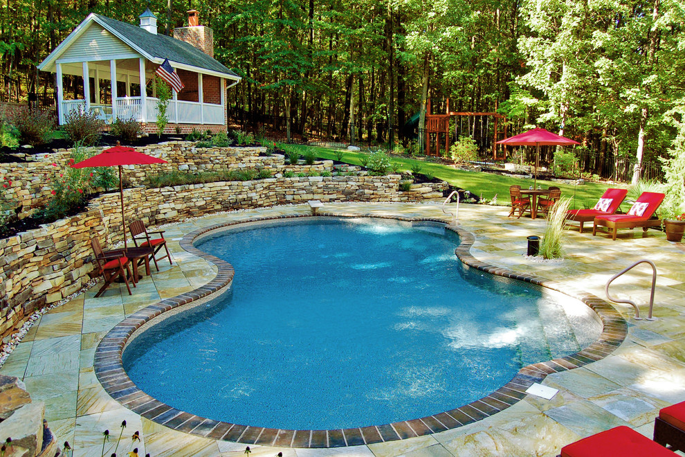 This is an example of a mid-sized traditional backyard custom-shaped lap pool in Other with tile.