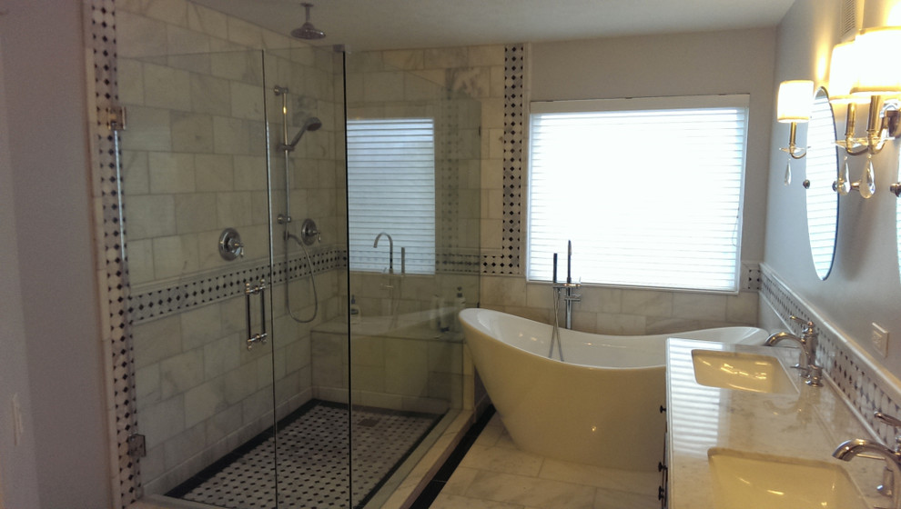 Freestanding bathtub - mid-sized transitional master gray tile and marble tile marble floor freestanding bathtub idea with white walls, an undermount sink and marble countertops