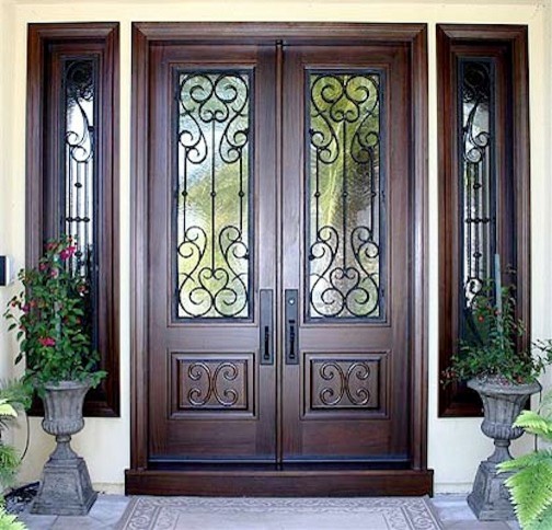 Inspiration for a large mediterranean ceramic tile front door remodel in Los Angeles with a dark wood front door and white walls