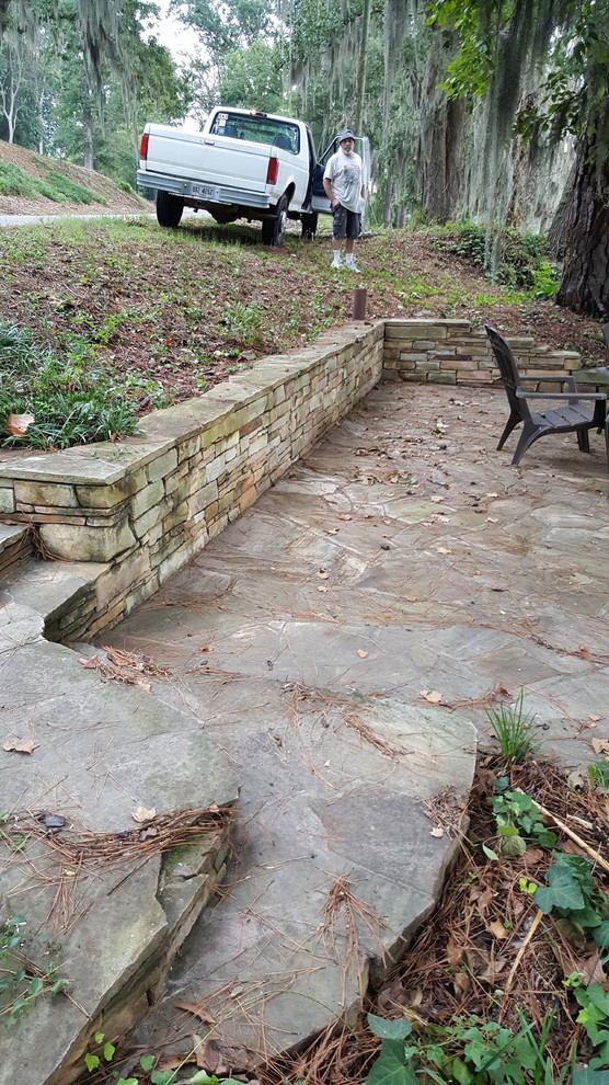 Inspiration for a mid-sized traditional backyard patio in Atlanta with natural stone pavers and no cover.