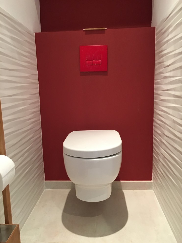 This is an example of a small modern powder room in Marseille with a wall-mount toilet, white tile, ceramic tile, red walls and ceramic floors.