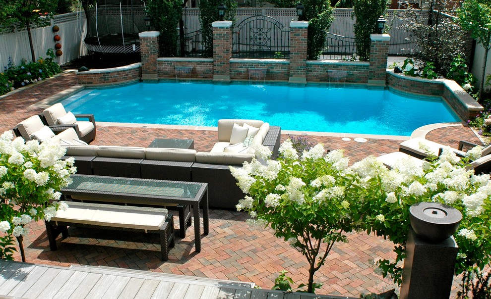 Inspiration for a large mediterranean backyard brick and custom-shaped pool fountain remodel