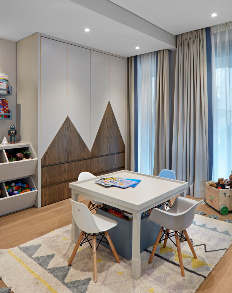 Design ideas for a large contemporary kids' playroom for kids 4-10 years old and boys in Other with grey walls and beige floor.