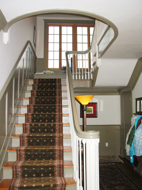 This is an example of a large arts and crafts carpeted straight staircase in Seattle with carpet risers.