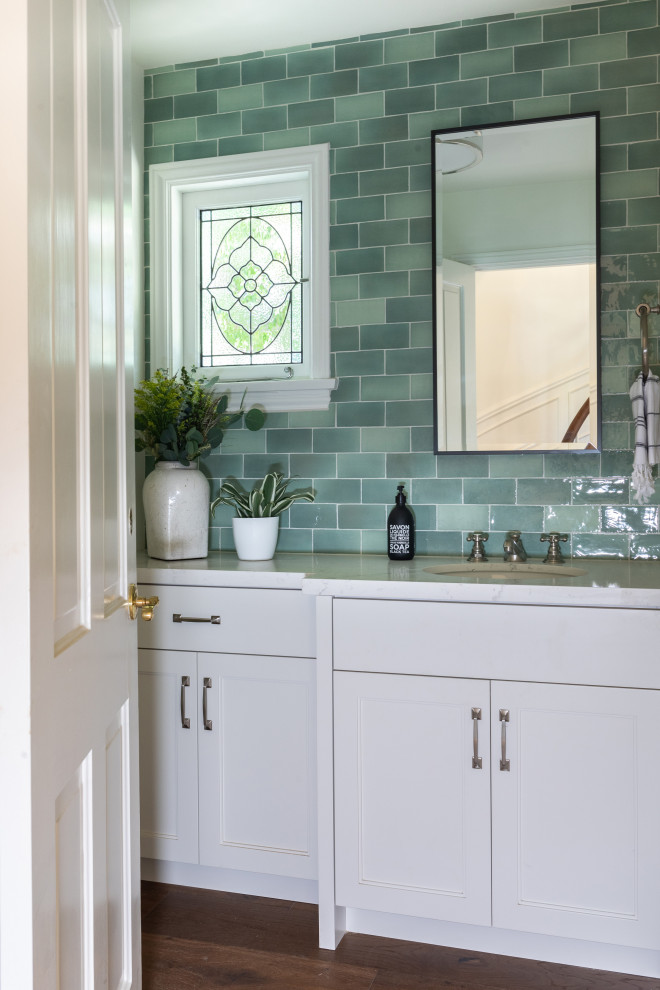 Inspiration for a small timeless green tile and ceramic tile medium tone wood floor and gray floor powder room remodel in Los Angeles with shaker cabinets, white cabinets, a one-piece toilet, white walls, an undermount sink, quartz countertops, white countertops and a built-in vanity